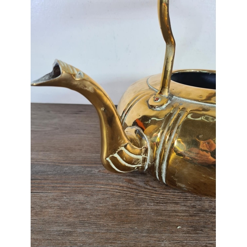 344 - A mid 20th century beaten brass kettle - approx. 25cm high x 35cm wide