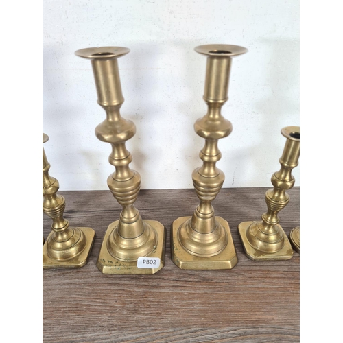 350 - Three pairs of brass candlesticks - largest approx. 22cm high