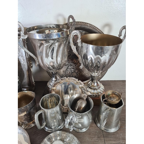 352 - A collection of metalware to include presentation trophies, cocktail shaker, trays etc.