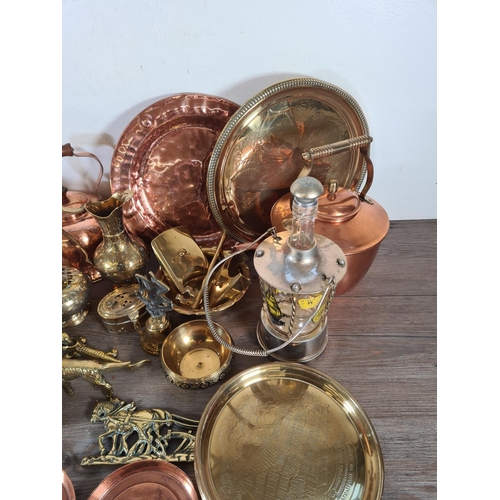 356 - A collection of metalware to include copper kettles, brass circular dishes, Lombard copper charger e... 