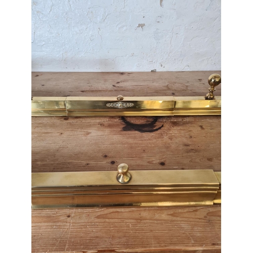 358 - Two brass fire fenders