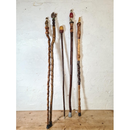 363 - Sixteen vintage novelty walking sticks to include owl, Egyptian etc.