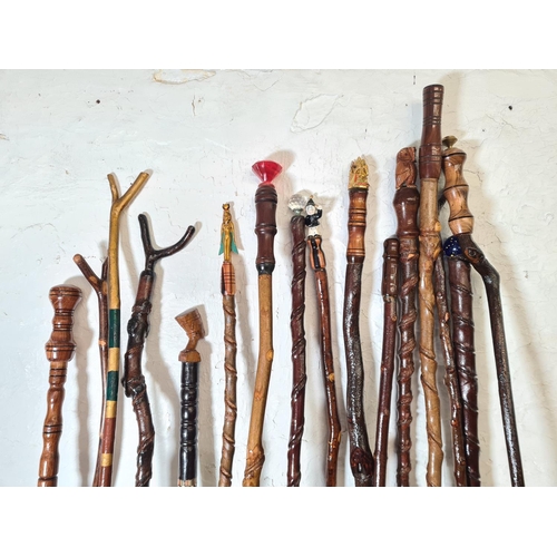 363 - Sixteen vintage novelty walking sticks to include owl, Egyptian etc.