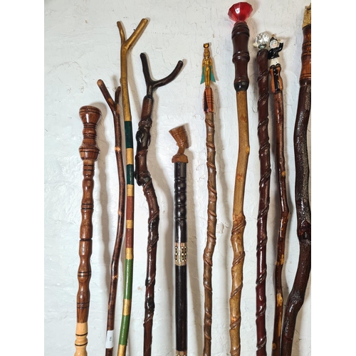 363 - Sixteen vintage novelty walking sticks to include owl, Egyptian etc.