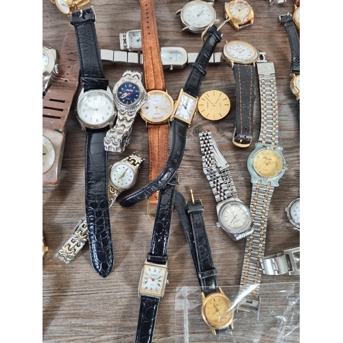 414 - A large collection of watches to include Timex, Saxon, Infinite etc.