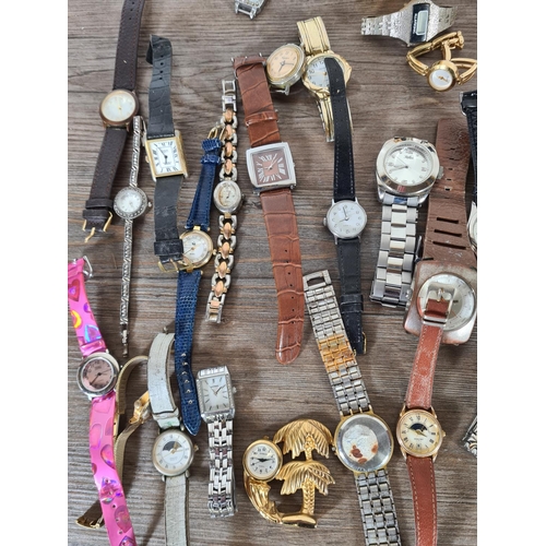 414 - A large collection of watches to include Timex, Saxon, Infinite etc.