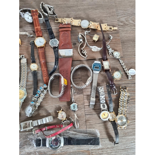 414 - A large collection of watches to include Timex, Saxon, Infinite etc.