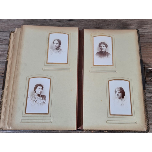 476 - A Victorian carte de visite album containing approx. thirty five cards