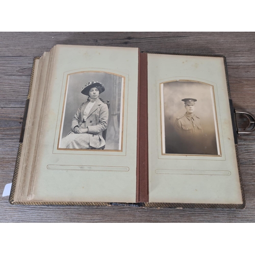 476 - A Victorian carte de visite album containing approx. thirty five cards