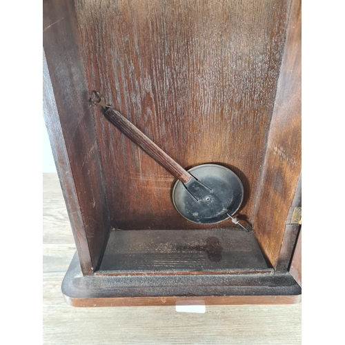 503 - A mid 20th century oak cased chiming wall clock with pendulum - approx. 78cm high x 33cm wide x 16cm... 