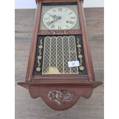 507 - A mid 20th century mahogany effect cased thirty one day chiming wall clock with pendulum and key - a... 