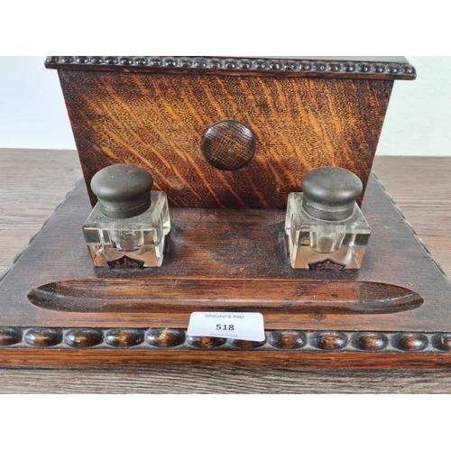 518 - An early 20th century oak desk tidy with two glass ink wells - approx. 15cm high x 28cm wide x 21.5c... 