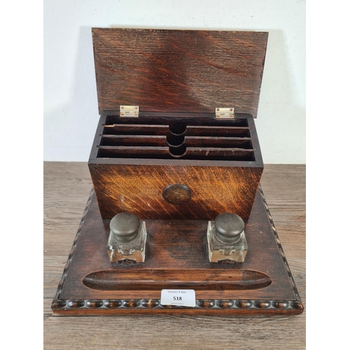 518 - An early 20th century oak desk tidy with two glass ink wells - approx. 15cm high x 28cm wide x 21.5c... 