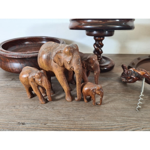 520 - A collection of treenware to include mahogany horse shoe shaped crumb tray, oak circular bowl, tree ... 