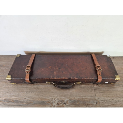 524 - A late 19th/early 20th century leather and brass gun case - approx. 9cm high x 84cm wide x 25cm deep