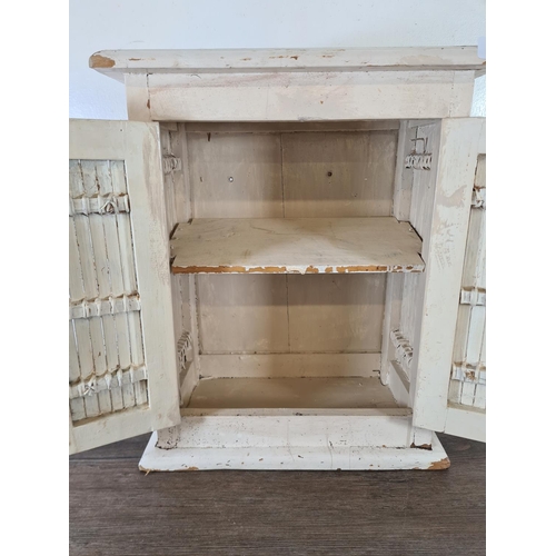 531 - A modern white painted wooden two door cabinet - approx. 44cm high x 35cm wide x 20cm deep