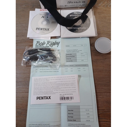 645 - A boxed Pentax K-x DSLR camera fitted with original smc Pentax-DA L 18-55mm 1:3.5-5.6 lens with soft... 