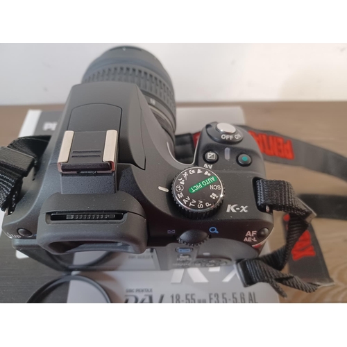 645 - A boxed Pentax K-x DSLR camera fitted with original smc Pentax-DA L 18-55mm 1:3.5-5.6 lens with soft... 