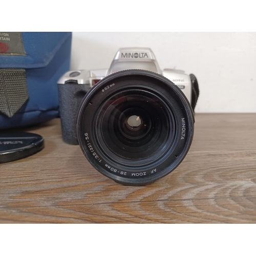 650 - A cased Minolta Dynax 404si 35mm SLR camera fitted with 28-80mm 1:3.5 (22)-5.6 lens