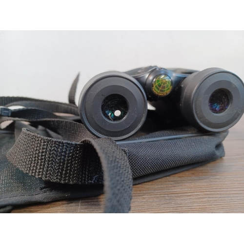 657 - Three pairs of binoculars to include cased Canon 8 x 32 WP 7.5° etc.