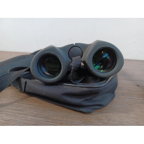 657 - Three pairs of binoculars to include cased Canon 8 x 32 WP 7.5° etc.