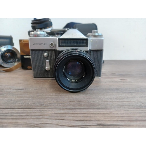 665 - Four items, one cased KMZ Zenit-E 35mm SLR camera, one boxed Olympus OM-System Zuiko f=50mm 1:1.8 MC... 