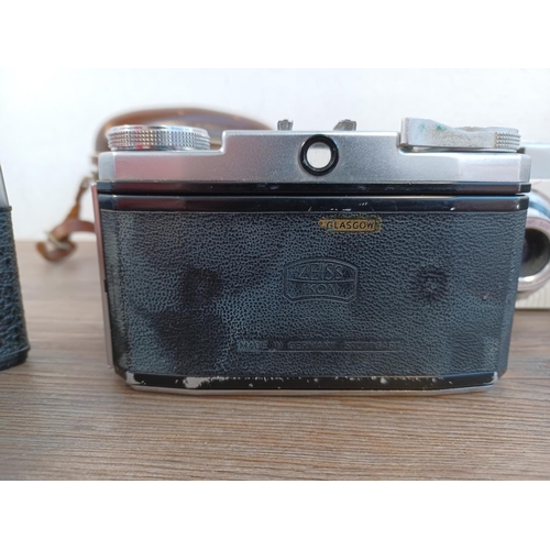 669 - Five 35mm cameras to include cased mid 1950s Zeiss Ikon Contina Ib fitted with Novicar-Anastigmat 1:... 