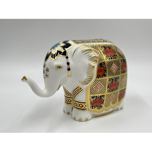 253 - A boxed Royal Crown Derby Elephant paperweight with gold stopper