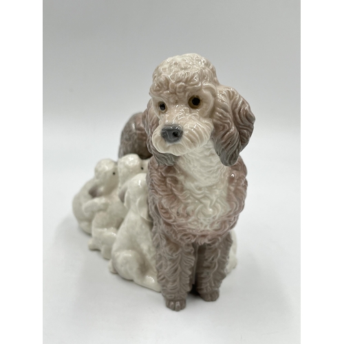 269 - A Lladro Mother Poodle with Puppies figurine, model no. 1257 - approx. 14cm high