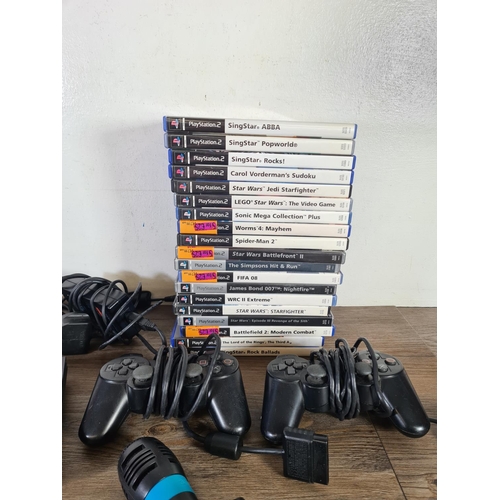 793 - A Sony PlayStation 2 Slim console with nineteen games and accessories