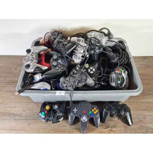 825 - A large collection of games console controllers