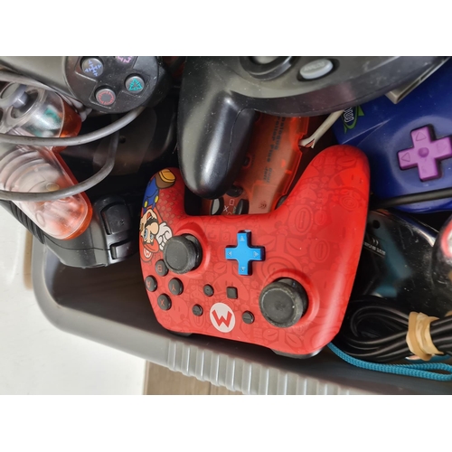 825 - A large collection of games console controllers