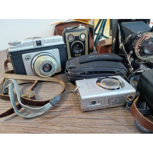 679 - A collection of cameras to include cased Ensign-Selfix 20 folding for 120 film, cased Kodak Retinett... 