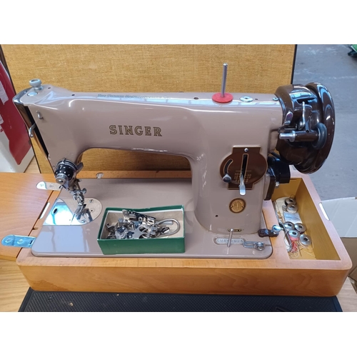 846 - A cased Singer 201K electric sewing machine with attachments and foot pedal