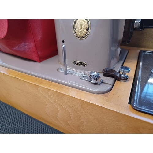 846 - A cased Singer 201K electric sewing machine with attachments and foot pedal