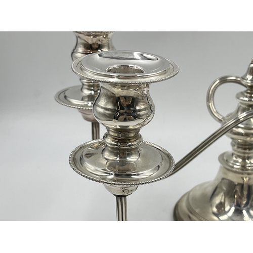 1245 - A pair of Elizabeth II Viner's Ltd. hallmarked Sheffield silver two branch candelabras, dated 1959 -... 