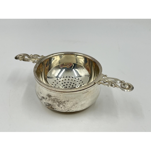 1249 - An Elizabeth II Henry Clifford Davis hallmarked Birmingham silver tea strainer, dated 1963 - approx.... 