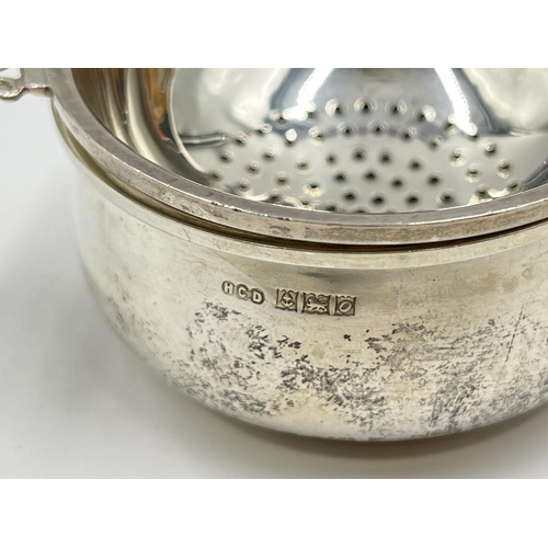 1249 - An Elizabeth II Henry Clifford Davis hallmarked Birmingham silver tea strainer, dated 1963 - approx.... 