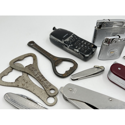 1237 - A collection of pocket knives, bottle openers and cigarette lighters