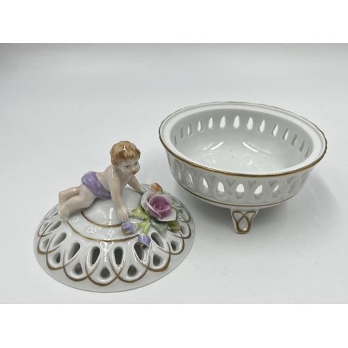 183 - Two pieces of Von Schierholz porcelain, pierced tri footed lidded circular trinket box and twin hand... 