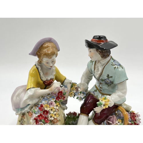 186 - A Sitzendorf hand painted porcelain flower seller group figurine - approx. 12.5cm high