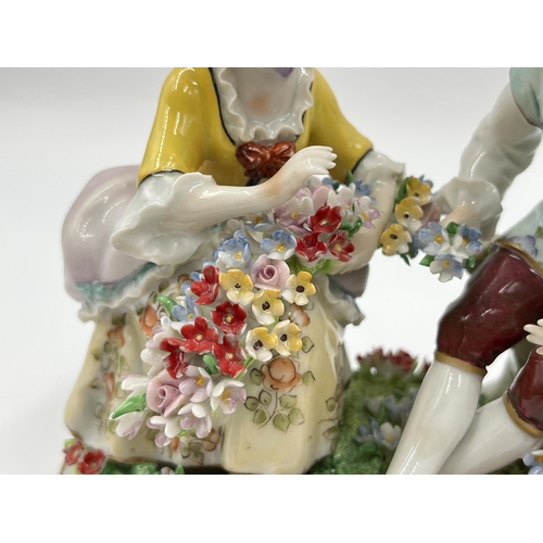 186 - A Sitzendorf hand painted porcelain flower seller group figurine - approx. 12.5cm high