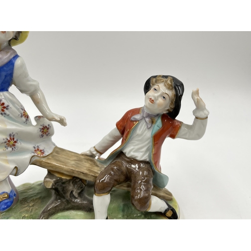 190 - A Volkstedt hand painted porcelain group figurine of two children on seesaw - approx. 15.5cm