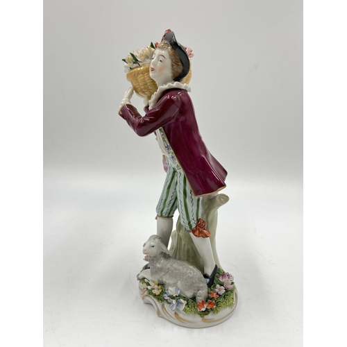 193 - A Sitzendorf hand painted porcelain figurine of a flower seller and sheep - approx. 19cm high