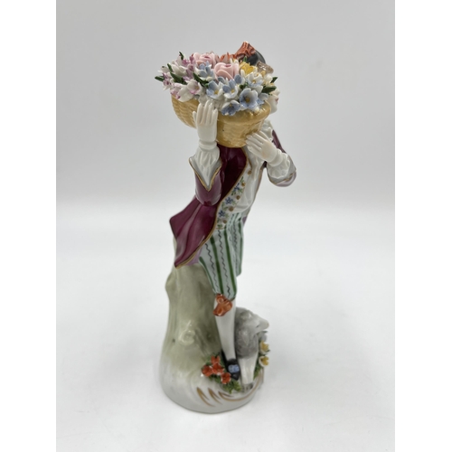 193 - A Sitzendorf hand painted porcelain figurine of a flower seller and sheep - approx. 19cm high