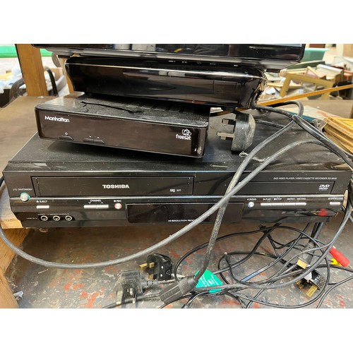 918 - A collection of house clearance items to include Polaroid DVD player, Toshiba SD-38VB DVD video play... 