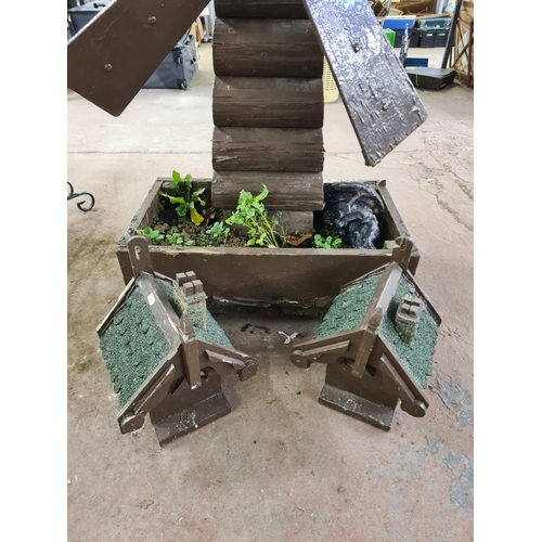 898 - Three wooden garden items, one windmill planter and two bird houses - windmill approx. 140cm high