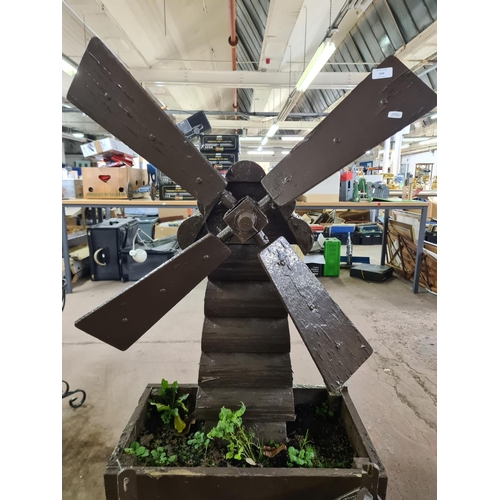 898 - Three wooden garden items, one windmill planter and two bird houses - windmill approx. 140cm high