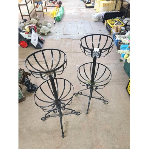 899 - A pair of Victorian style wrought iron two tier plant stands - approx. 91cm high