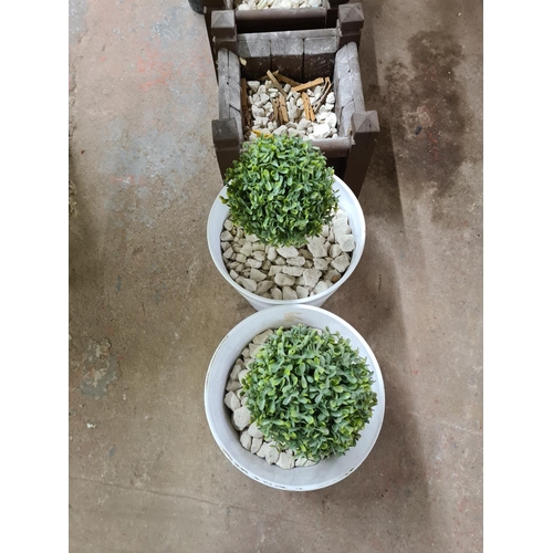 900 - Four potted artificial outdoor plants